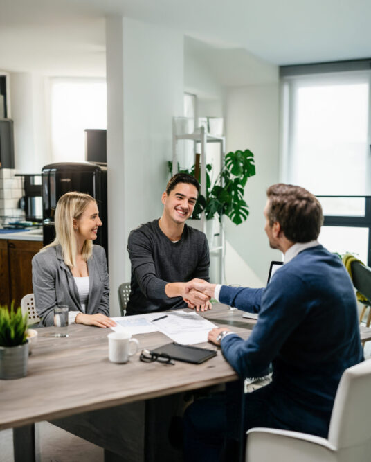 young-happy-couple-making-agreement-with-their-financial-advisor-home-men-are-shaking-hands (1) young-happy-couple-making-agreement-with-their-financial-advisor-home-men-are-shaking-hands (1)